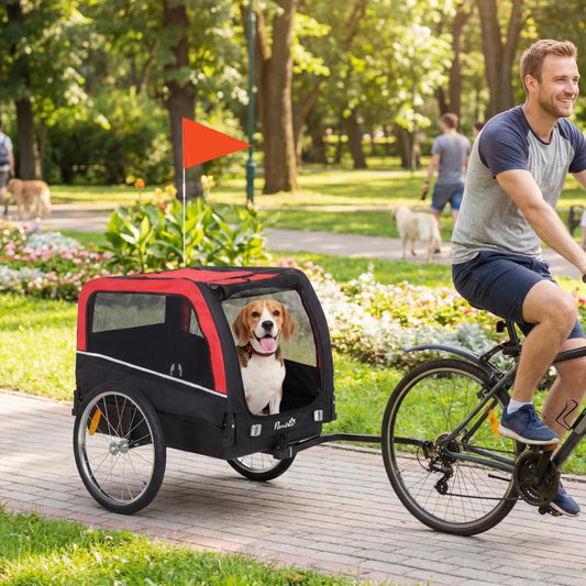 Dog bike trailer with red canopy, mesh sides, and a dog seated inside