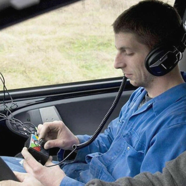 Technician using car electronic stethoscope headset to test vehicle engine components