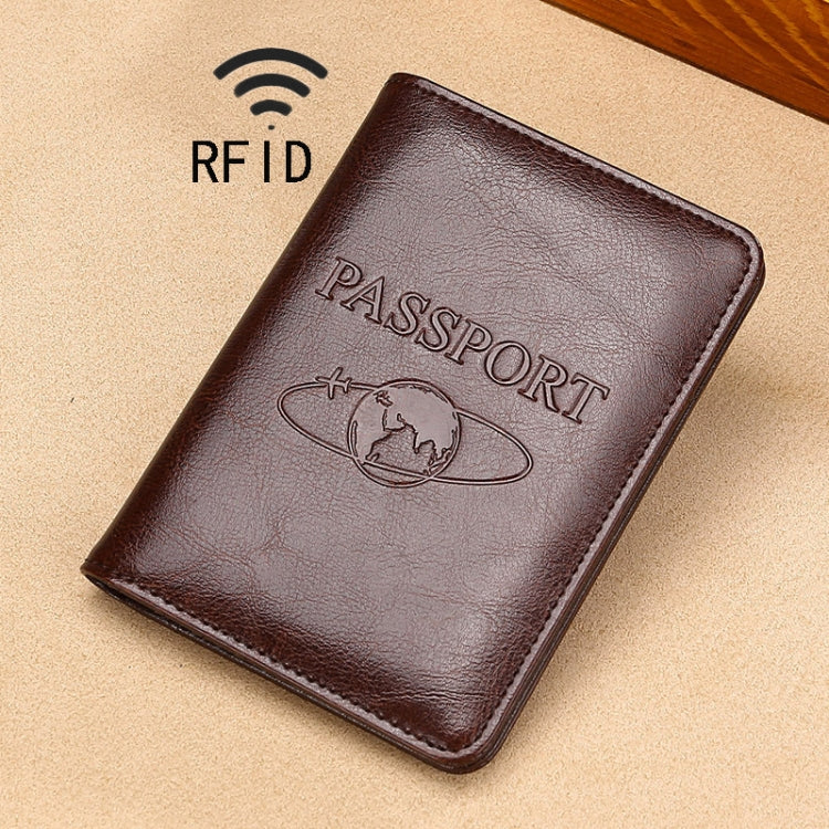 Dark brown RFID leather passport holder with embossed PASSPORT and globe emblem.