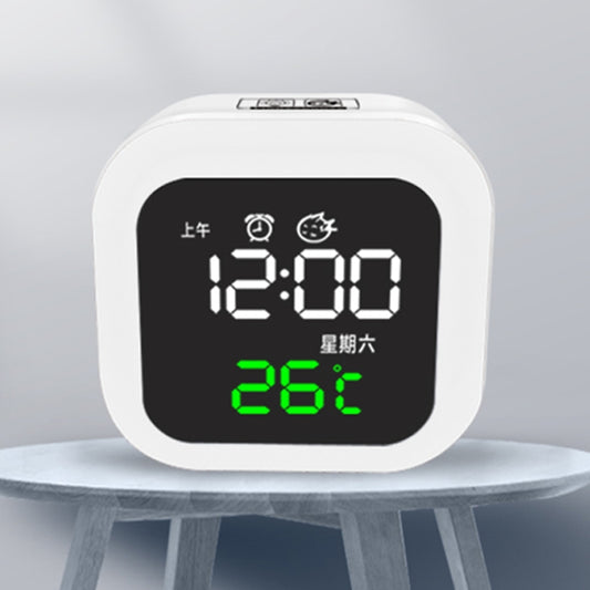 White digital bedside clock with black screen showing 12:00 and 26°C; night light on