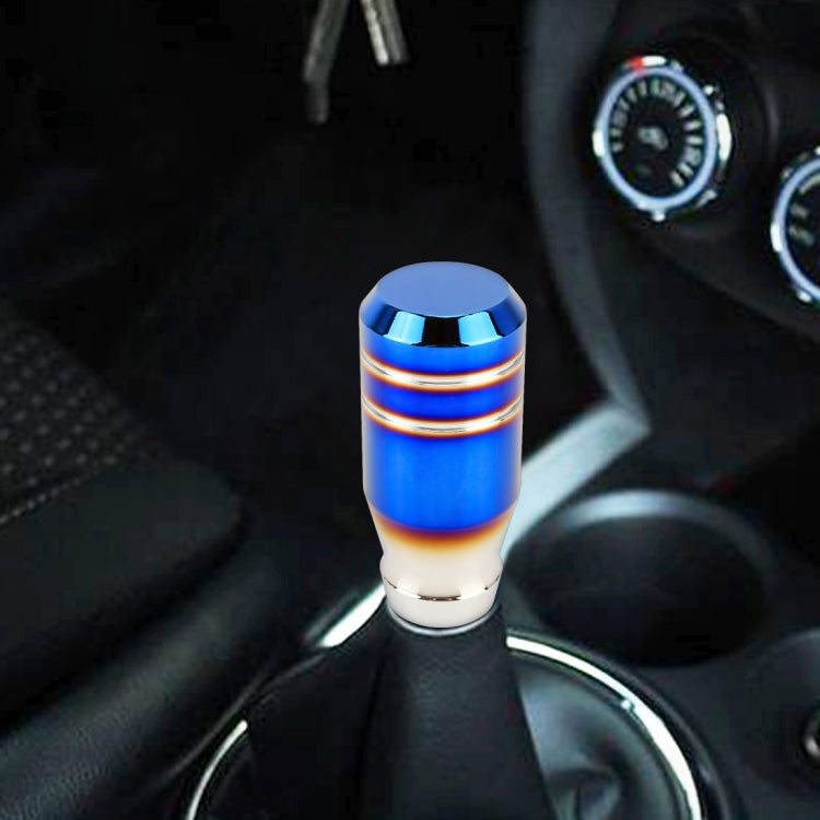 Blue car shifter knob with chrome rings and white base, installed on gear lever