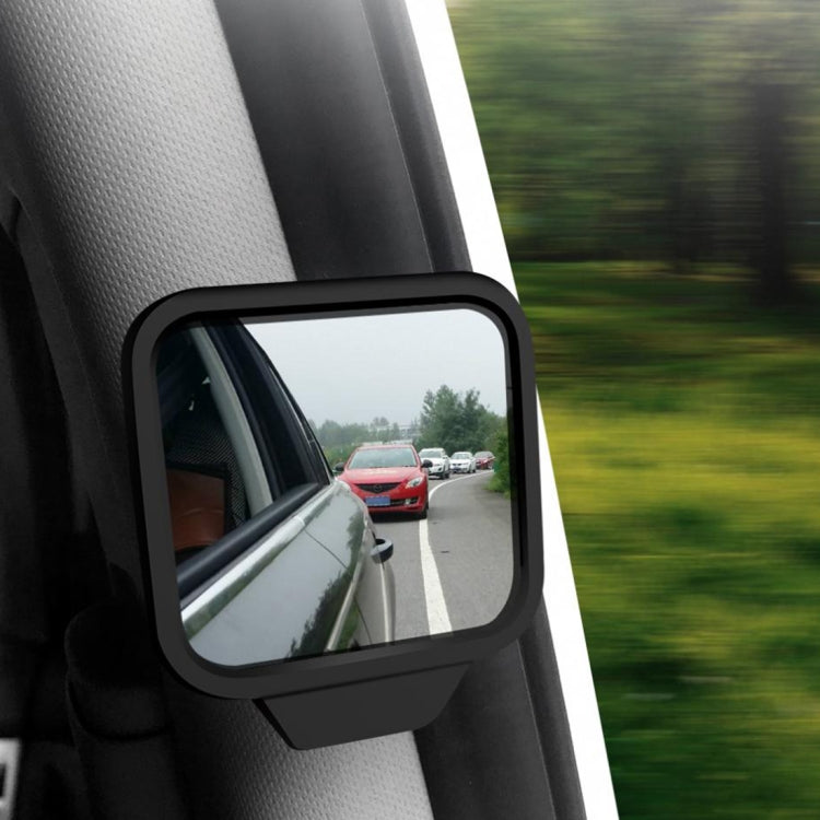 Wide-angle blind spot mirror mounted on side panel, reflecting vehicles behind