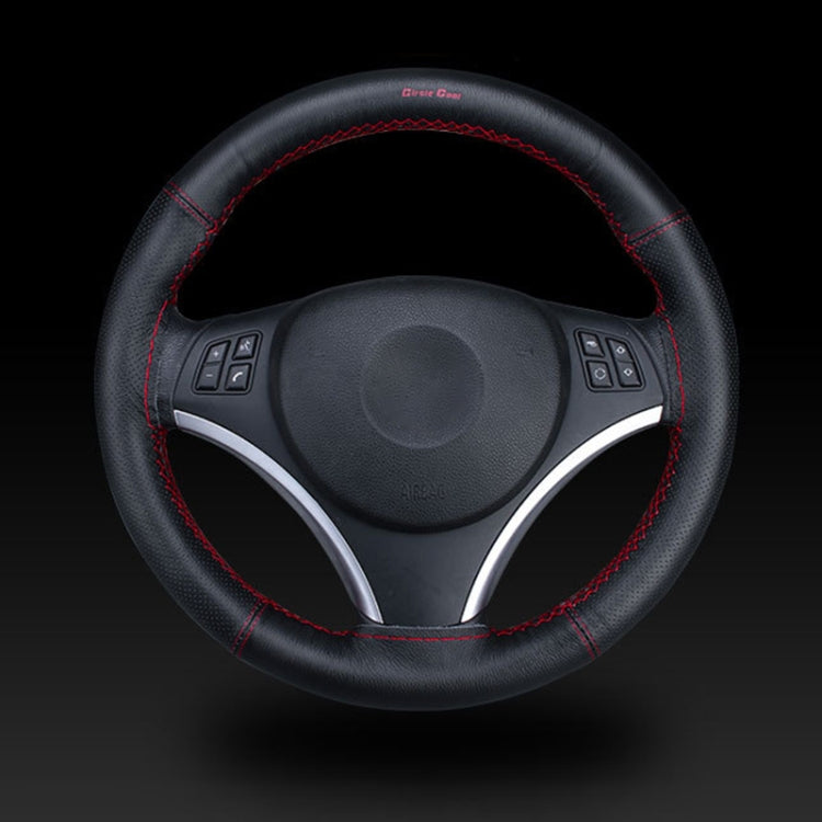 Black leather steering wheel cover with red hand-stitched seam and control cutouts