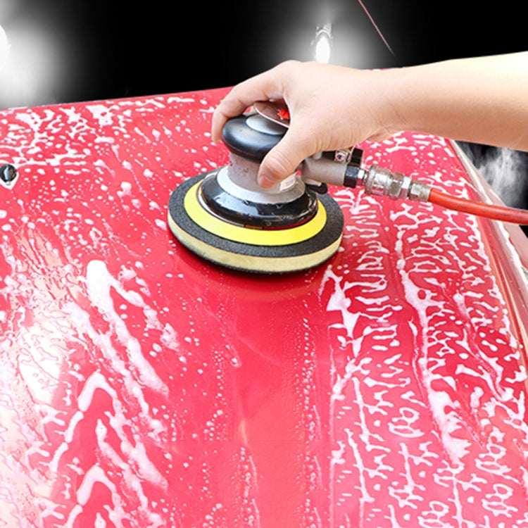Car polishing grinding disk being used on a red vehicle panel with rotary tool
