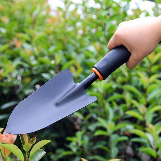Gardening digging shovel with dark metal blade and long black plastic handle