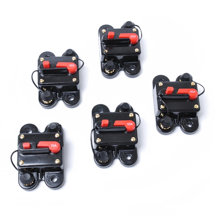 Assorted auto-reset DC fuse holders, black with red reset buttons and varied amp labels