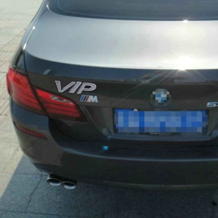 Silver 'VIP' metal decal on car rear with glossy finish