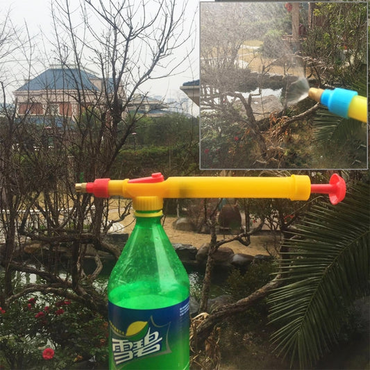 Yellow manual pressure bottle sprayer gun with red nozzle, attached to green bottle