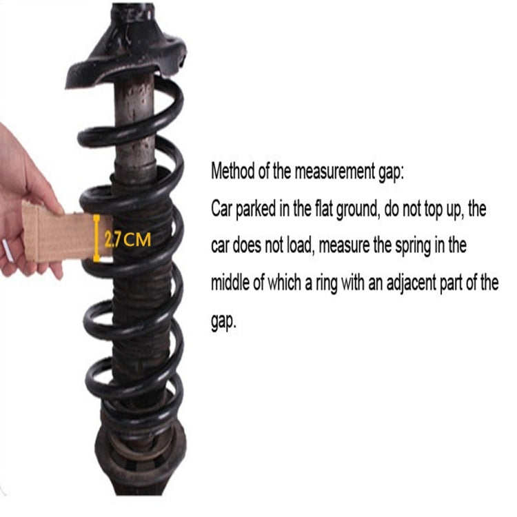 Coiled shock absorber with clear spacer buffer ring measuring a 2.7 cm gap