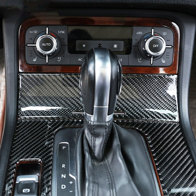 Carbon fiber cigarette lighter panel trim on dashboard, dark woven texture around shifter