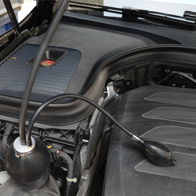 Inflatable leak plug and hose connected near car engine intake area