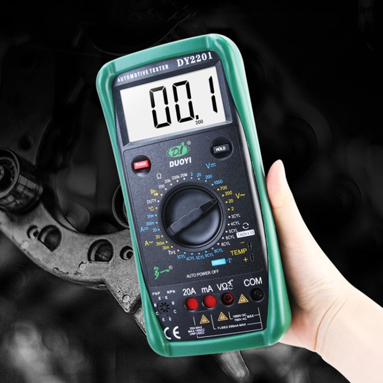 Green automotive digital multimeter tester held in hand with LCD reading 000.1