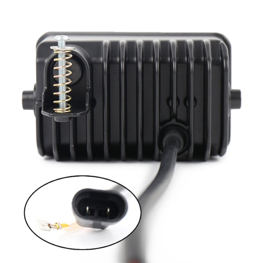 Back view of black fog light unit with visible spring and electrical connector port