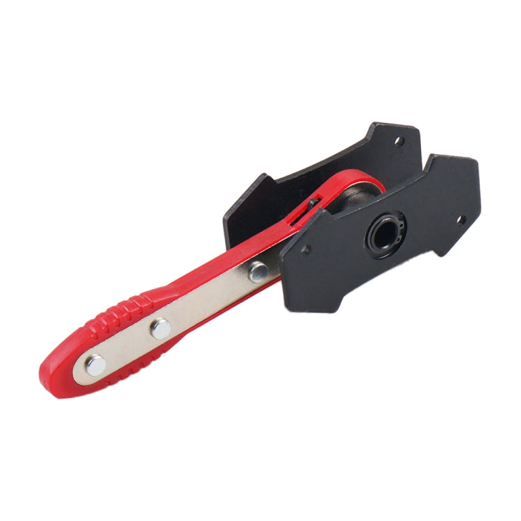 Red brake piston spreader tool with black caliper pad bracket and ratchet handle