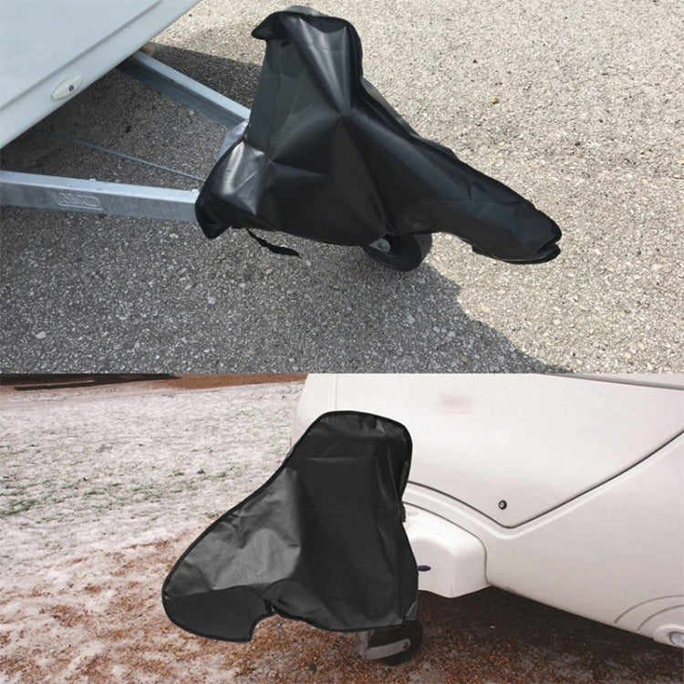 Black towing hitch cover fitted over hitch, with strap tie on driveway and roadside