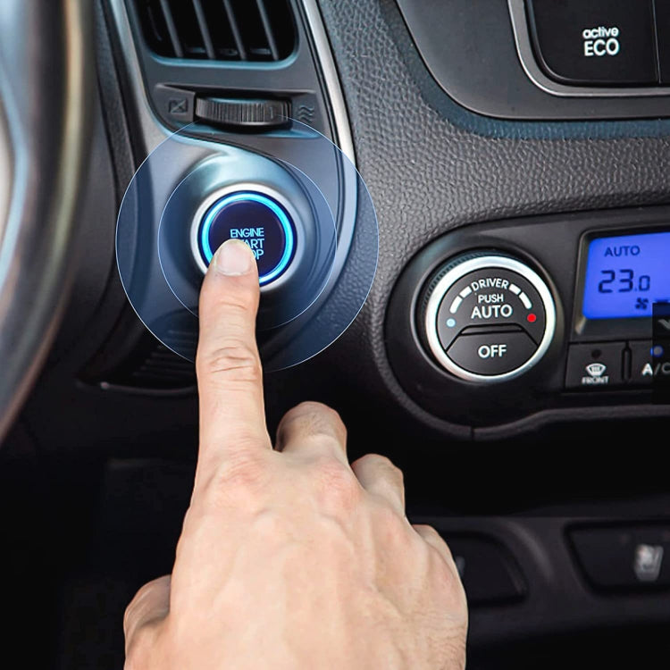 Engine Start button ignition switch being pressed on a car dashboard