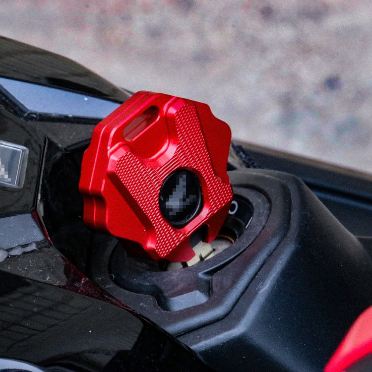 Red motorcycle key shell mounted on the bike with a textured grip