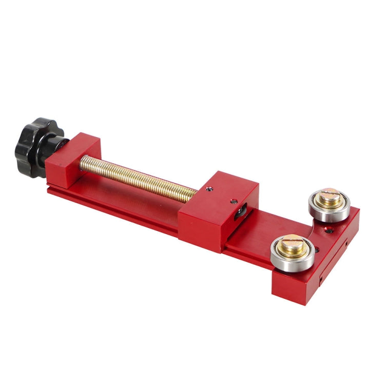 Red oil filter cutter tool with clamping posts and threaded rod adjustment
