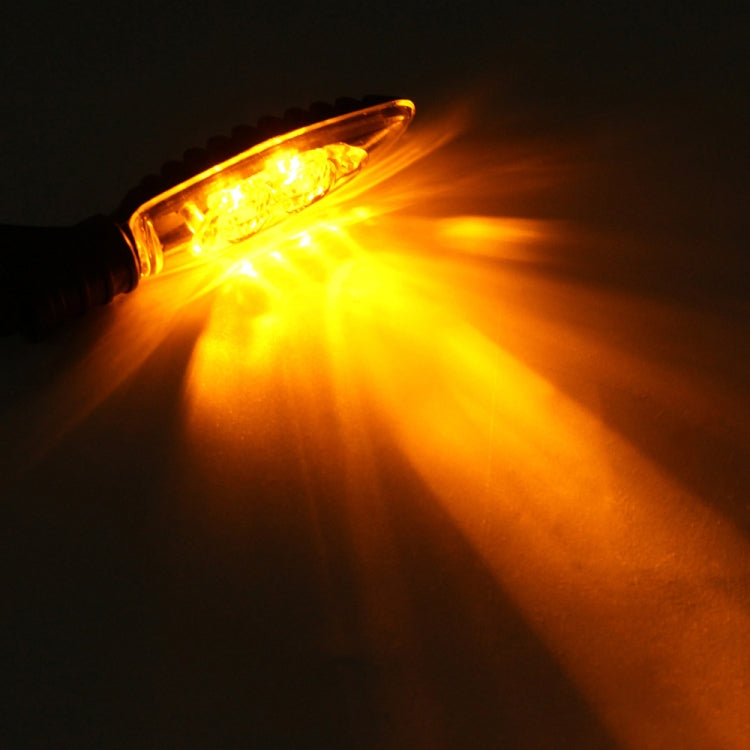 Glowing amber LED front turn signal light with curved clear lens