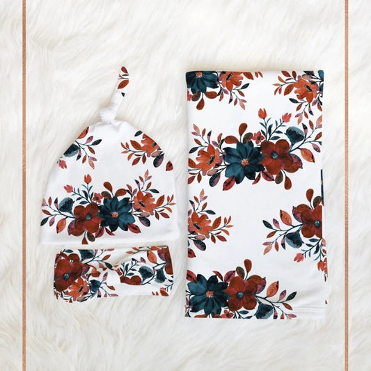 Floral newborn swaddling set with cap and headband, white with teal and rust flowers