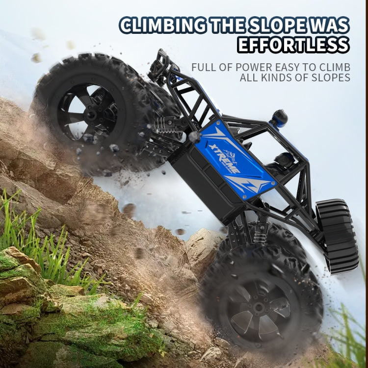 Blue and black RC climbing truck angled on a rocky slope with deep tread tires
