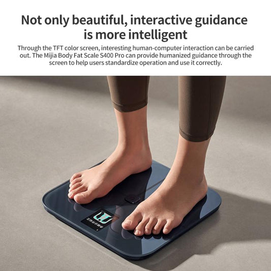 Body fat scale with screen as feet stand on the dark platform