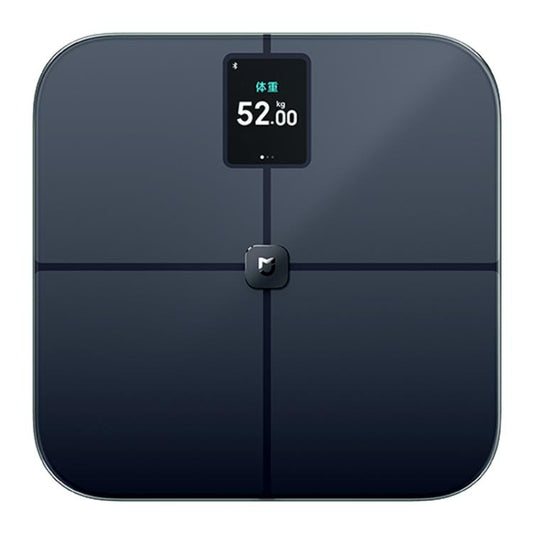 Dark glass body fat scale with central display reading 52.00 kg