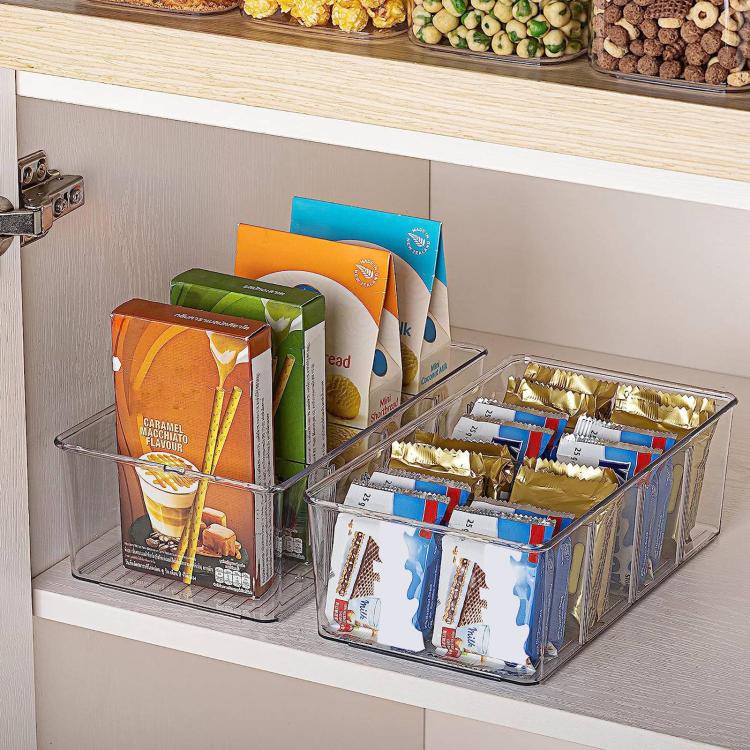 Clear organizer box with four compartments and vertical dividers for stacked snack packages