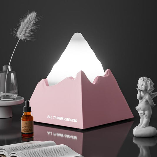 Pink mini volcano aroma diffuser night light, glowing white peak and cutout sides