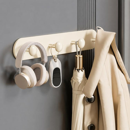 Cream magnetic hook rail with rounded hooks holding an umbrella and hanging accessories