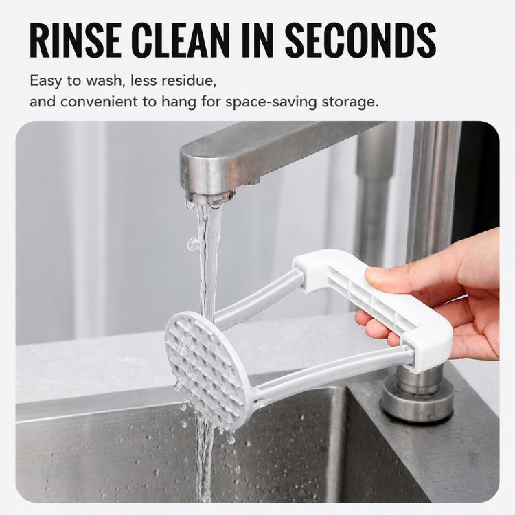 Manual potato masher with white plastic mashing head and metal handle, rinsed under faucet