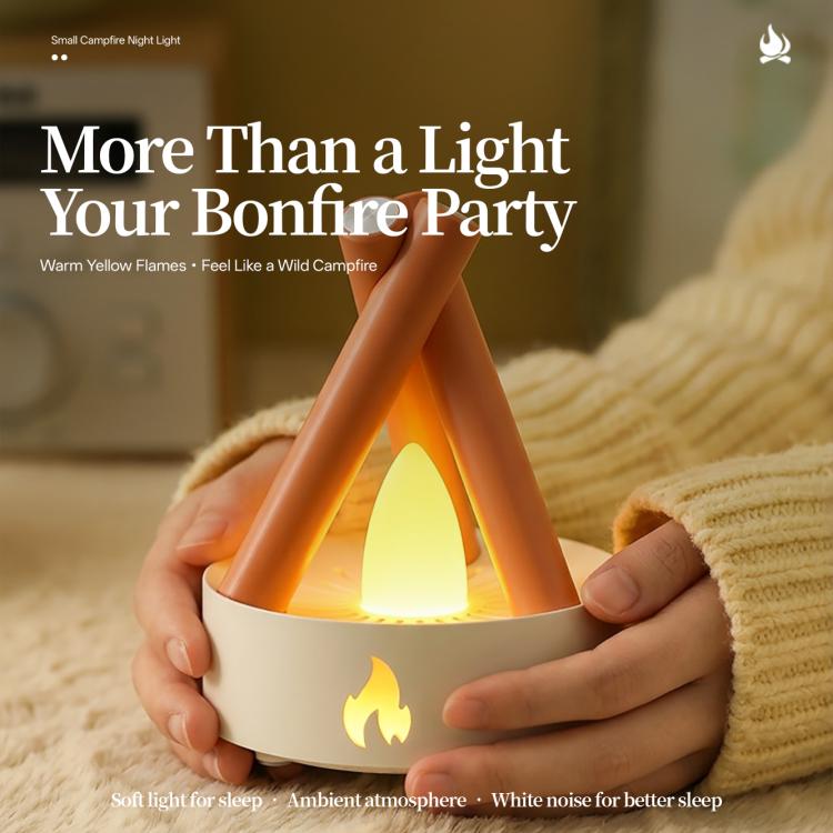 Orange campfire night light held in hands with a glowing yellow flame effect.