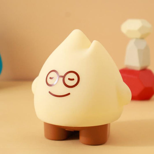 Beige flame night light with cute face, round glasses, and smiling mouth