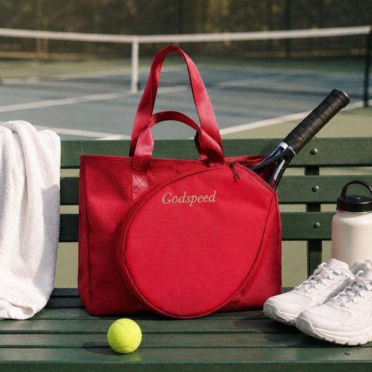 Red tennis racket travel tote bag with round front pocket and top handles, holding a racket