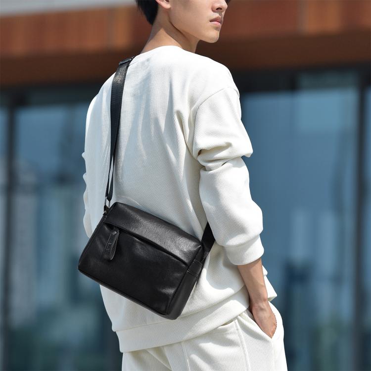 Black PU leather crossbody bag worn on shoulder, rectangular shape with zipper closure.