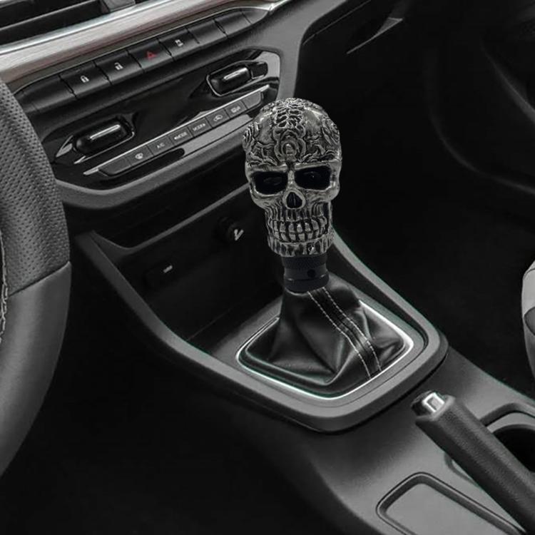 Gray skull-style manual gear shift knob shown on car interior shift lever