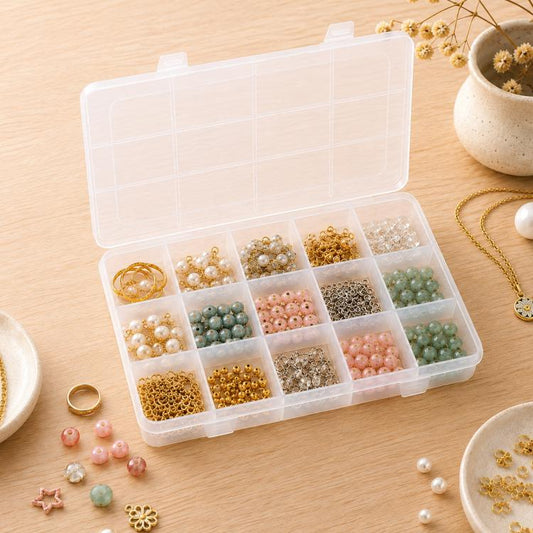 Clear plastic organizer box with hinged lid and 15 fixed compartments, open with beads