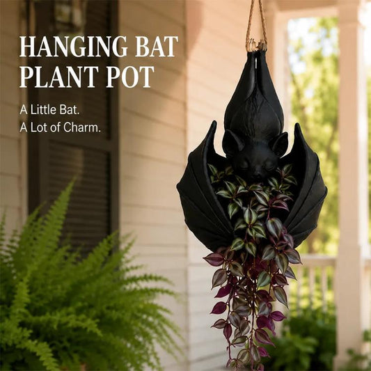 Hanging bat-shaped plant pot with black bat body and purple-and-green stems
