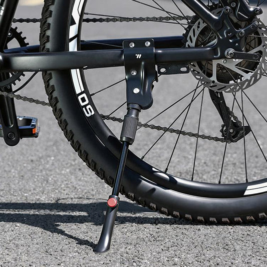 Adjustable bicycle kickstand with black metal legs and red height button