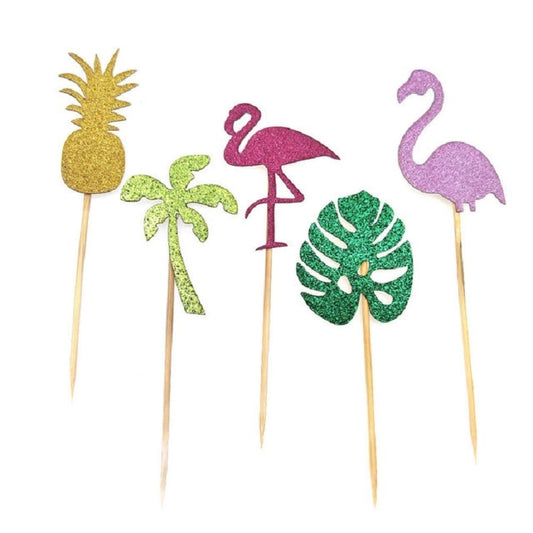 Holiday party dessert topper sticks featuring flamingos, pineapple, and tropical leaf shapes