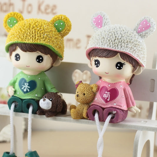 Pair hanging dolls on a shelf: green outfit and pink outfit with bear-hat heads and teddies