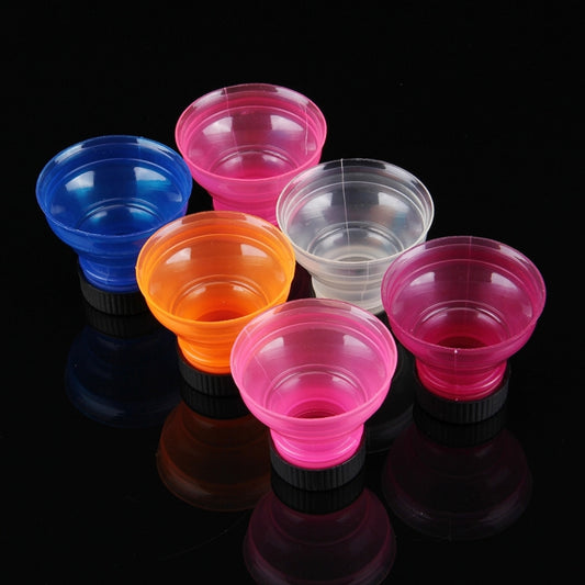 Assorted translucent seal caps in blue, pink, orange, and clear with black ribbed lids