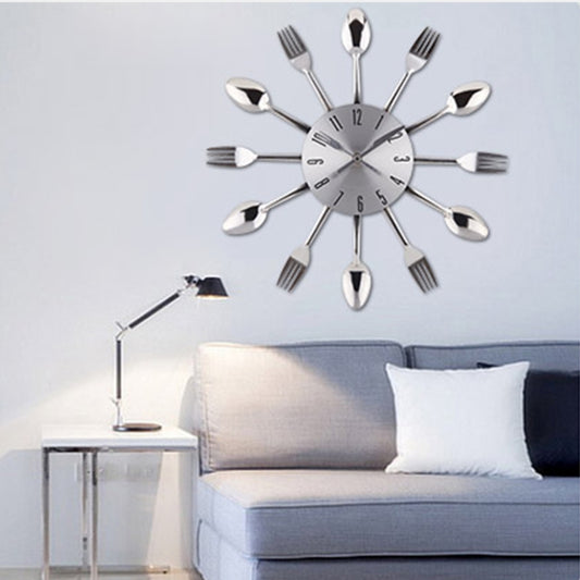 Utensil-themed wall clock with silver fork and spoon arms, round white dial