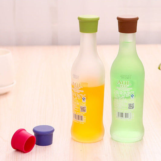 Candy color silicone bottle stoppers on bottles, green and brown caps with extra caps