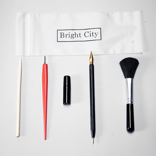 Scratch painting tool set: red stylus, black pen, and detail paint brush