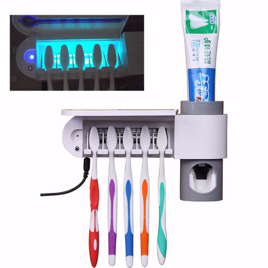 Automatic toothpaste dispenser with UV sterilizer, gray base, six toothbrushes in holder
