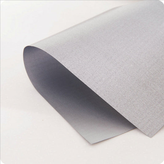 Silver stovetop protective pad sheet with textured surface, shown folded for edge view