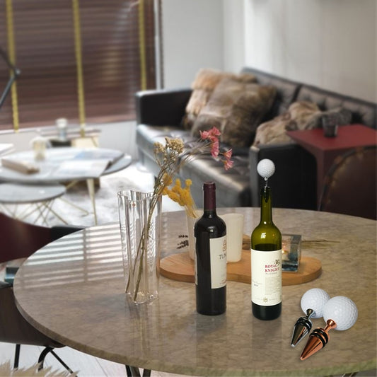 Golf tee bottle stoppers with white golf balls and metal tips beside wine bottles