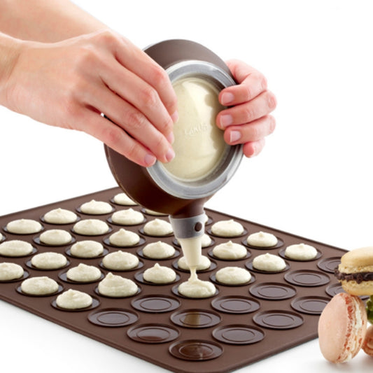 Silicone macaron baking mold tray with piping tip and filled molds, brown
