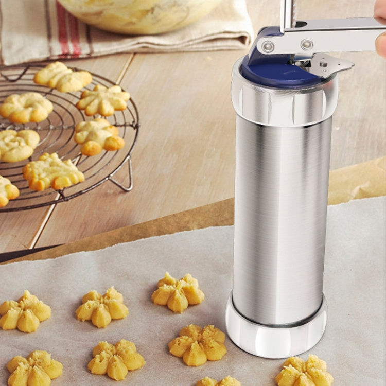 Silver cookie press on parchment with shaped cookies around it